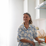 Thumbnail of older woman standing in a kitchen