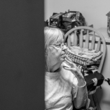 Small image of woman in her kitchen looking concerned