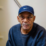 Thumbnail photo of Man with blue shirt and blue hat