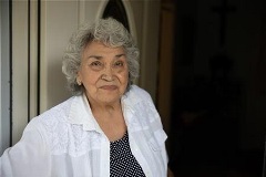 Woman smiling in front of door