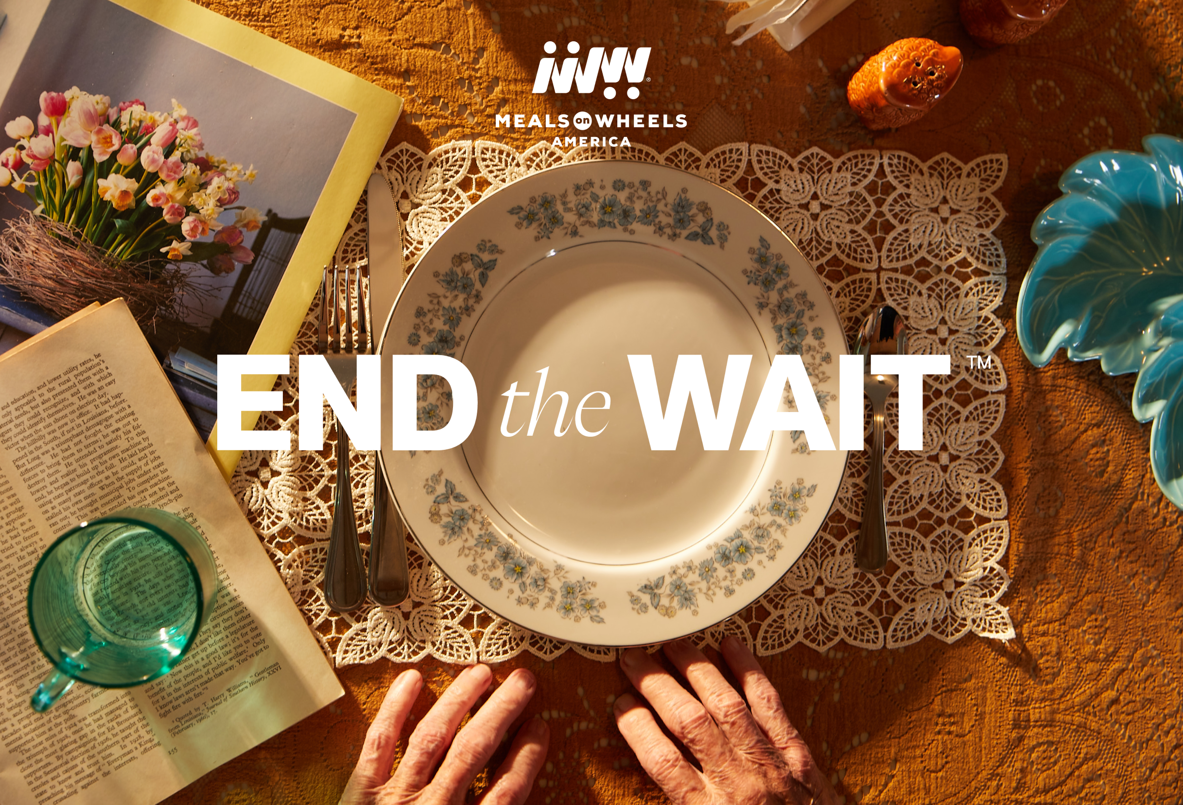 Woman waiting in front of an empty dinner plate with a very long knitted scarf