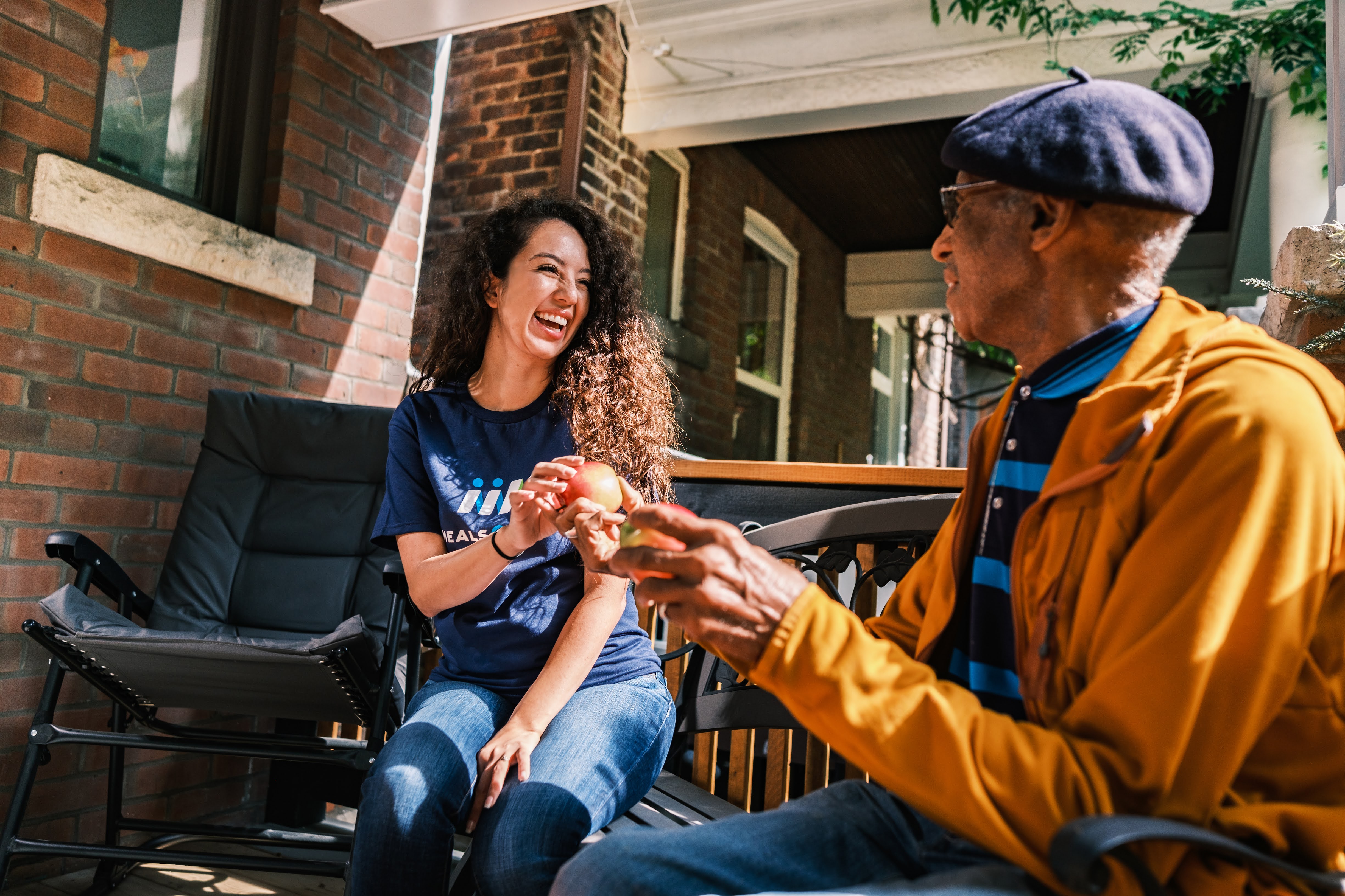 Volunteer and client sharing food